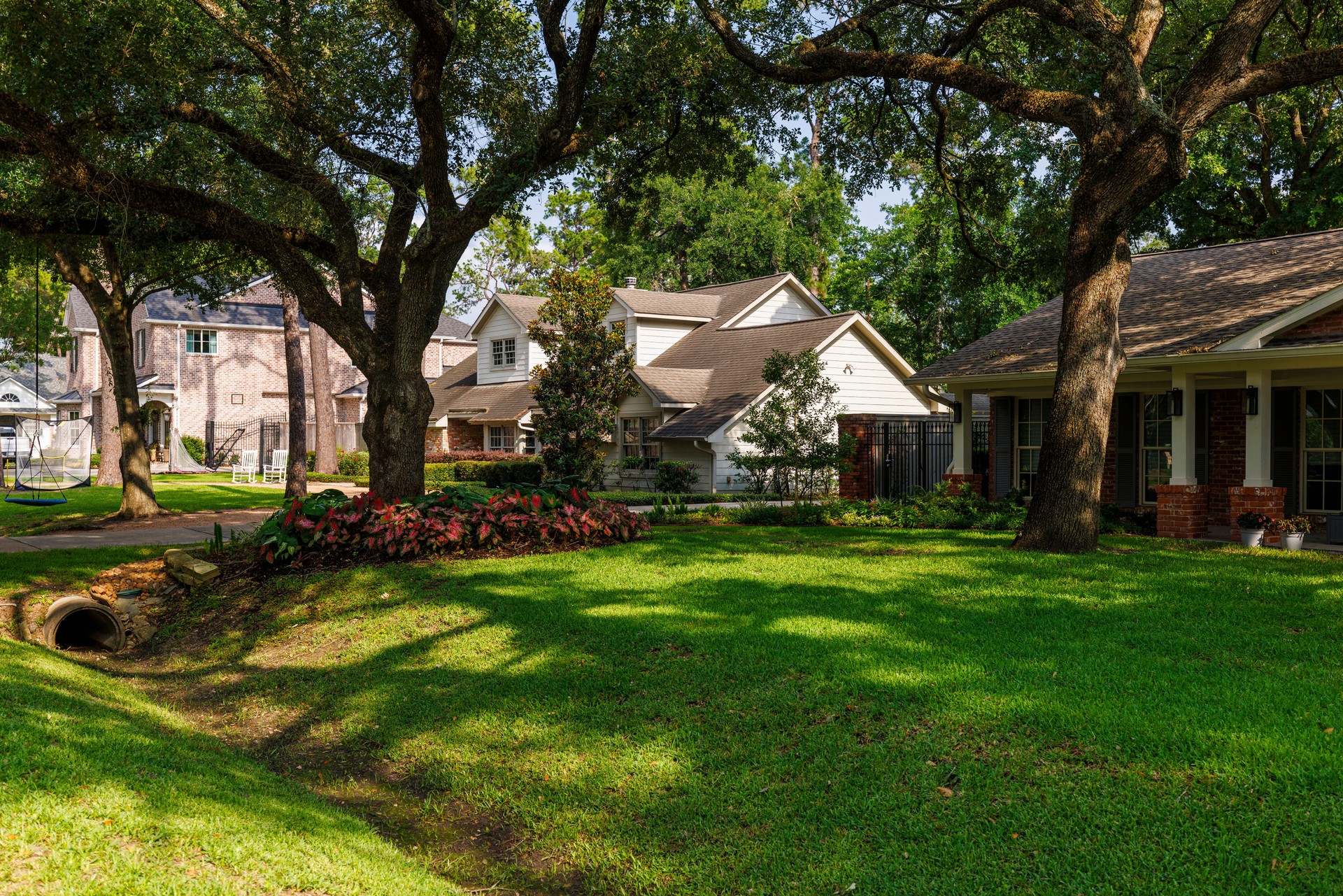 Strolling through shaded wealthy neighborhood. Residential neighborhood adorn tree-lined street in East Houston, TX